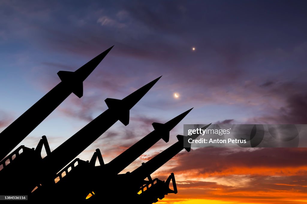 Threat of nuclear war. Missile system on the background of sunset sky