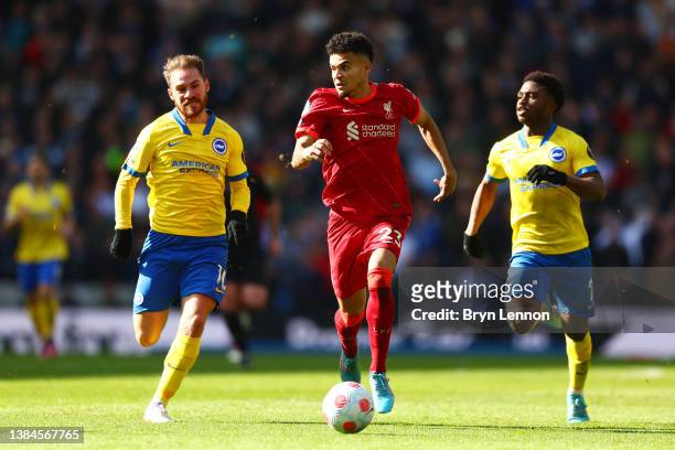 Luis Diaz of Liverpool battles for possession with Alexis Mac Allister and Tariq Lamptey of Brighton & Hove Albion during the Premier League match...
