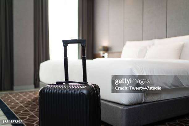 a suitcase placing in front of the bedroom in luxury hotel room - hotel suite fotografías e imágenes de stock