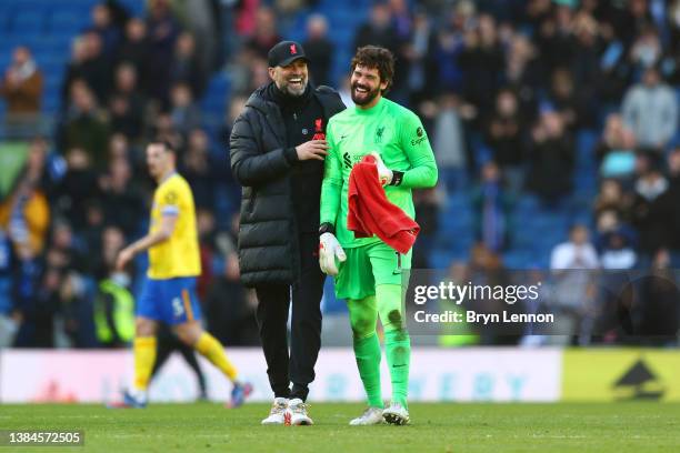 Juergen Klopp, Manager of Liverpool and Alisson Becker of Liverpool interact following their side's victory in the Premier League match between...