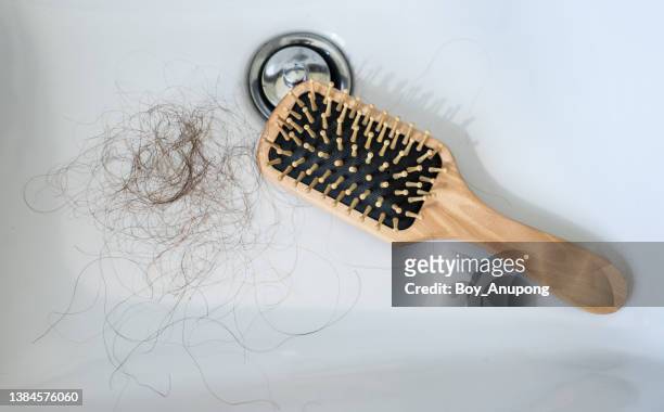 woman's hair loss fall in bathroom sink. - thin fotografías e imágenes de stock