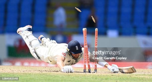 Jonathan Bairstow of England dives to make his ground during day five of the first test match between West Indies and England at Sir Vivian Richards...