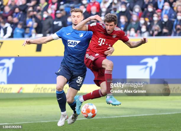 Thomas Mueller of FC Bayern Muenchen is challenged by Stefan Posch of TSG 1899 Hoffenheim during the Bundesliga match between TSG Hoffenheim and FC...