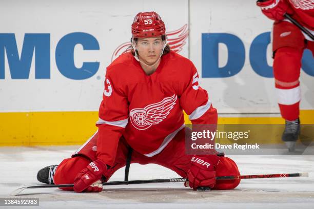 Moritz Seider of the Detroit Red Wings stretches during warm ups before an NHL game against the Minnesota Wild at Little Caesars Arena on March 10,...