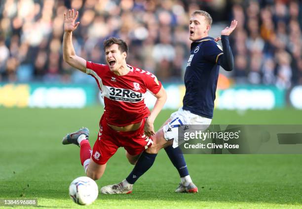 Paddy McNair of Middlesbrough is challenged by George Saville of Millwall during the Sky Bet Championship match between Millwall and Middlesbrough at...