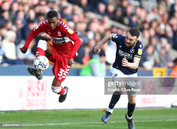 Isaiah Jones of Middlesbrough controls the ball in front of Scott Malone of Millwall during the Sky Bet Championship match between Millwall and...