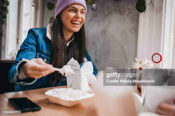two cheerful women having fun in a chinese restaurant - taking a break 個照片及圖片檔