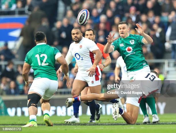 Jonathan Sexton of Ireland offloads the ball during the Guinness Six Nations Rugby match between England and Ireland at Twickenham Stadium on March...