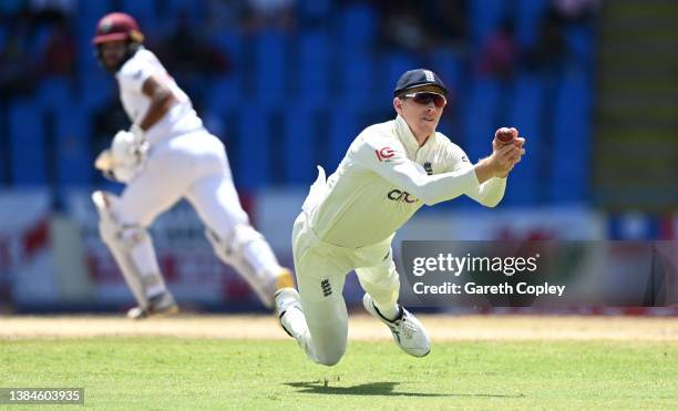 Zak Crawley of England fails to hold up to a catch from John Campbell of the West Indies during day five of the first test match between West Indies...