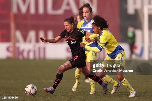 Sara Gama of Juventus tussles with Miriam Longo of AC Milan during the Women's Coppa Italia Semi Final 1st Leg match at Campo Sportivo Vismara on...