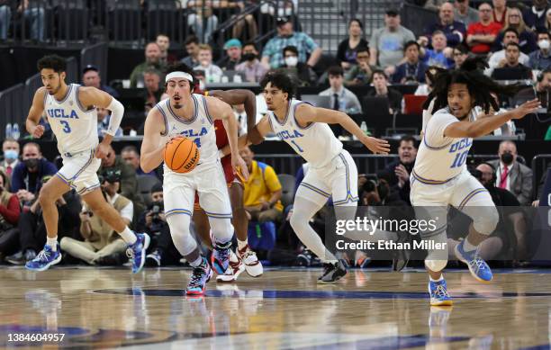 Jaime Jaquez Jr. #24 of the UCLA Bruins brings the ball up the court off of a Colorado Buffaloes turnover followed by teammates Johnny Juzang, Jules...