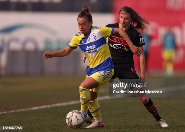 Lisa Boattin of Juventus is pursued by Christy Grimshaw of AC Milan during the Women's Coppa Italia Semi Final 1st Leg match at Campo Sportivo...