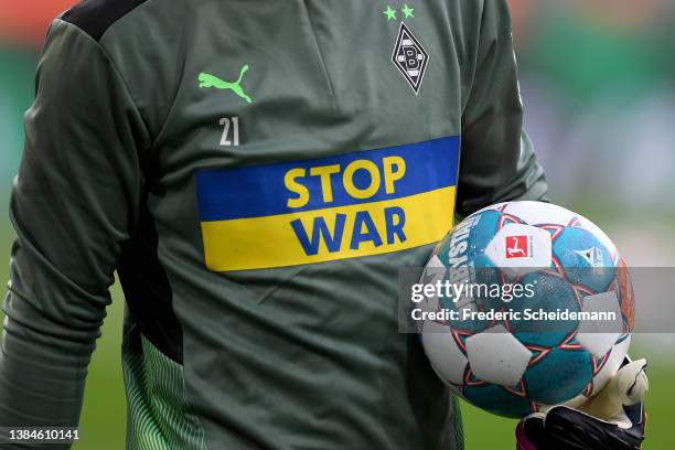 Detail view of a Borussia Moenchengladbach warm up jersey to indicate peace and sympathy with Ukraine prior to the Bundesliga match between Borussia...