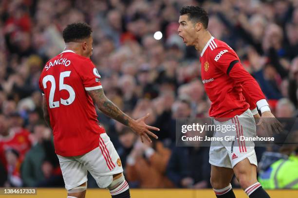 Cristiano Ronaldo of Manchester United celebrates with Jadon Sancho after scoring the opening goal during the Premier League match between Manchester...