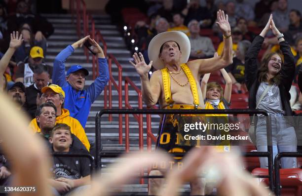 Wyoming Cowboys fan Ken "Cowboy Ken Barrel Man" Koretos of Wyoming cheers during a semifinal game of the Mountain West Conference basketball...