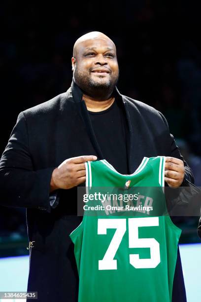 Former Boston Celtics player Antoine Walker holds up a jersey during halftime of the game between the Boston Celtics and the Detroit Pistons at TD...