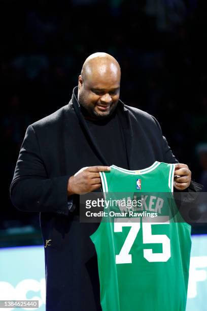 Former Boston Celtics player Antoine Walker holds up a jersey during halftime of the game between the Boston Celtics and the Detroit Pistons at TD...