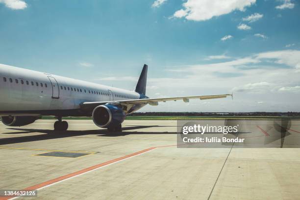 airplane parked on the airfield - runway stock-fotos und bilder