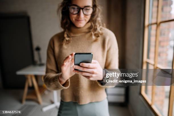 beautiful woman texting a friend - scrolling stock pictures, royalty-free photos & images