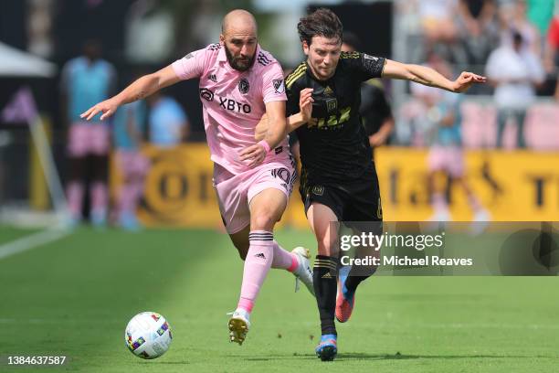 Gonzalo Higuaín of Inter Miami CF and Ilie Sánchez of Los Angeles FC battle for control of the ball during the first half at DRV PNK Stadium on March...