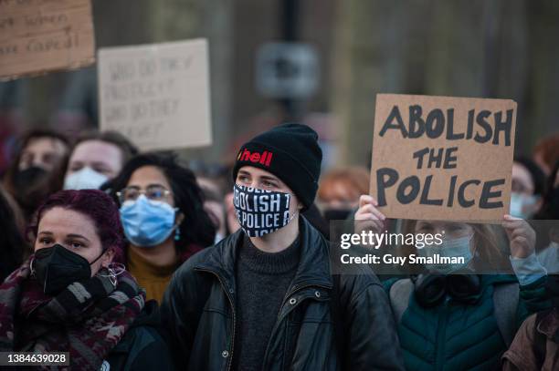 Activists attend a protest, called by Sisters Uncut, outside Scotland Yard, where they blocked the road before marching towards the West End on March...