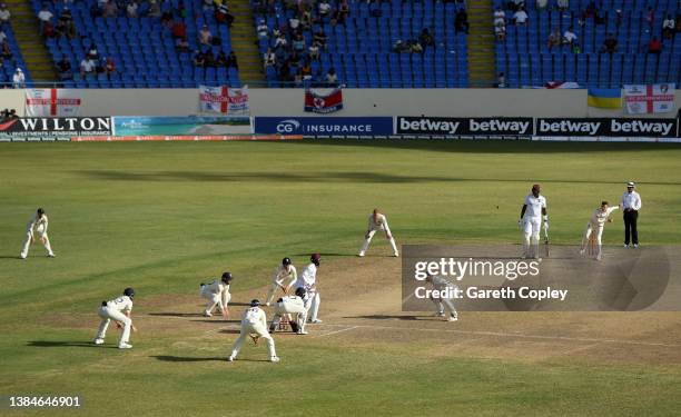 Dan Lawrence of England to Nkrumah Bonner of the West Indies with close in catchers during day five of the first test match between West Indies and...