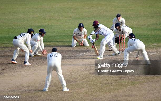 Jason Holder of the West Indies defends the ball surrounded by England close fielders during day five of the first test match between West Indies and...