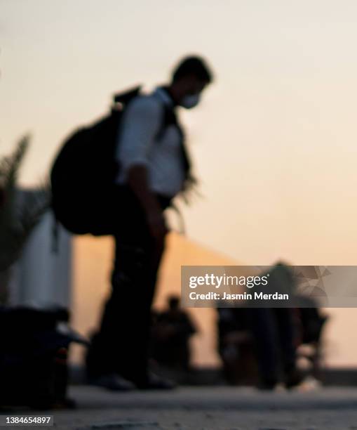 sad defocused man with backpack - displaced people fotografías e imágenes de stock