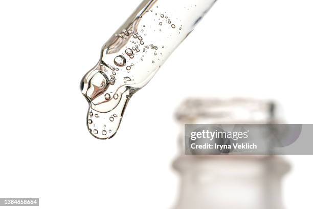 close-up pipette with face serum or essential oil with oxygen aqua bubbles and bottle for cosmetic on a white color background, isolated. - ha stock pictures, royalty-free photos & images