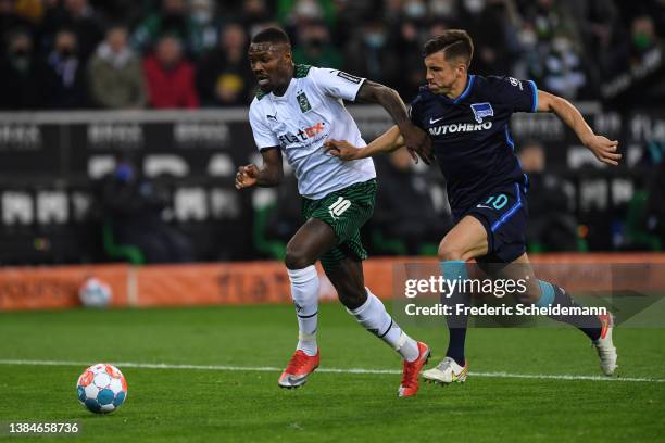 Marcus Thuram of Moenchengladbach is challenged by Marc-Oliver Kempf of Berlin during the Bundesliga match between Borussia Mönchengladbach and...