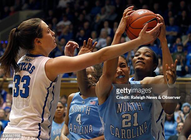 Duke forward Haley Peters and forward Richa Jackson contest a rebound with North Carolina forward Krista Gross during game action at Cameron Indoor...