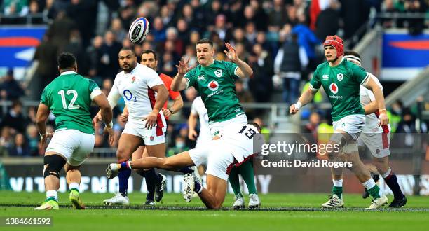 Johnny Sexton of Ireland off loads the ball during the Guinness Six Nations Rugby match between England and Ireland at Twickenham Stadium on March...