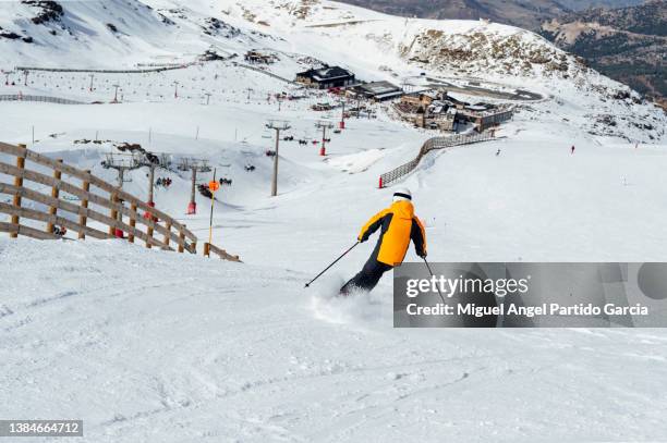 man skiing in a ski resort.sierra nevada.spain - sierra nevada spain ski photos et images de collection