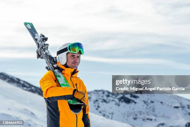 man with ski looking away while walking on snow covered valley - sierra nevada spain ski photos et images de collection