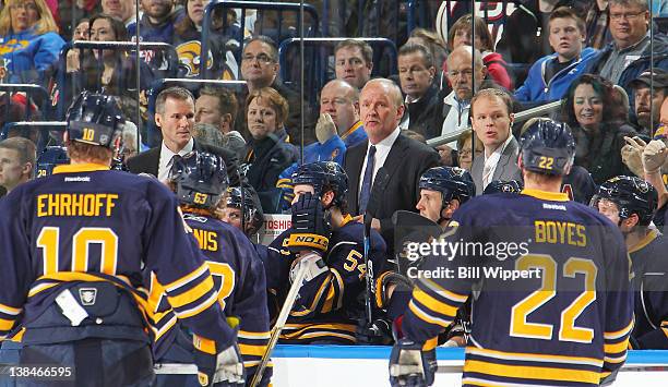 Head coach Lindy Ruff and assistant coaches James Patrick and Kevyn Adams of the Buffalo Sabres talk to players in a game against the New York...