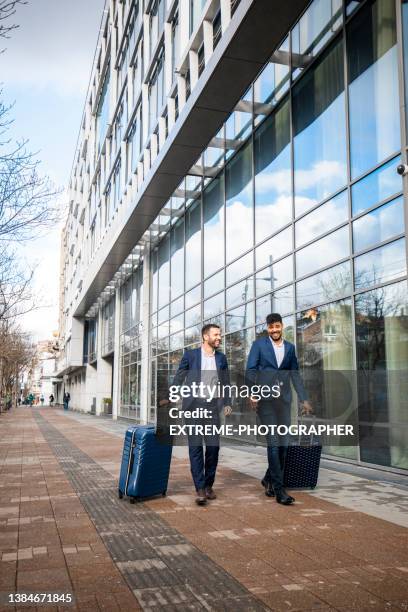 businessmen seen in front of the hotel - suite stock pictures, royalty-free photos & images