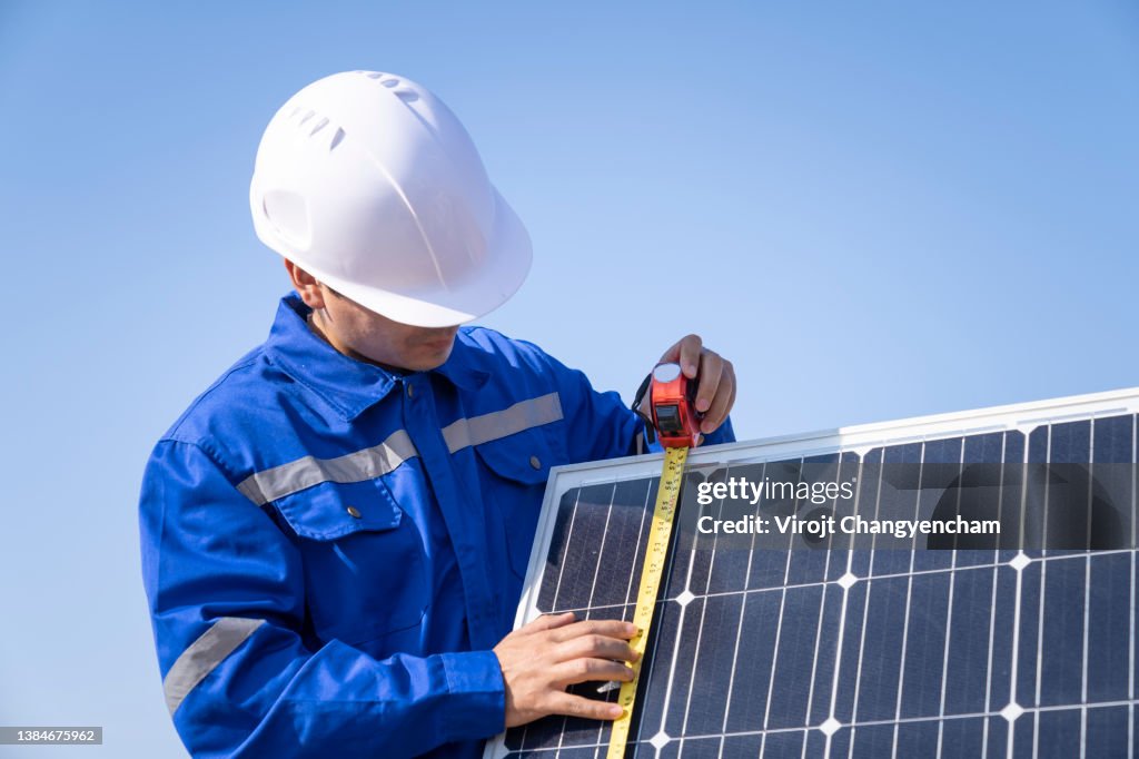 Worker measurement solar cell panel on site