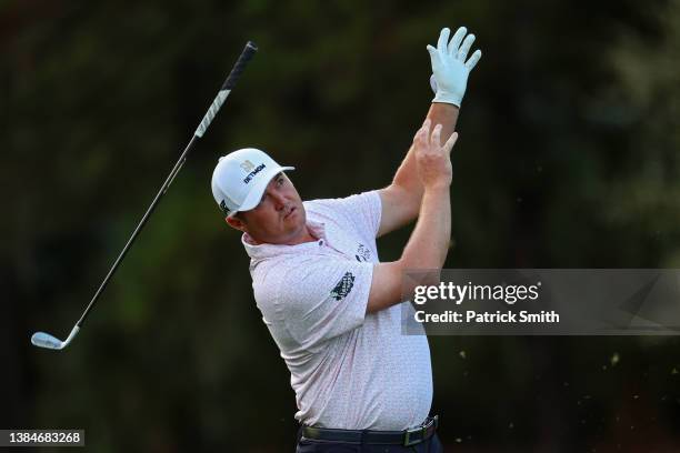 Jason Kokrak of the United States lets go of his club after hitting a shot on the tenth hole during the first round of THE PLAYERS Championship on...