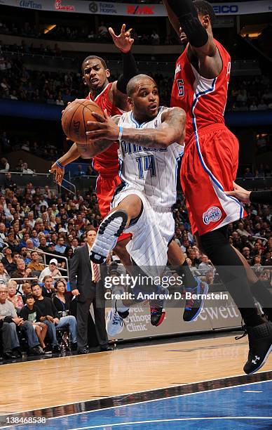 Jameer Nelson of the Orlando Magic leaps in the air as he attempts a pass against Chris Paul and DeAndre Jordan of the Los Angeles Clippers during...