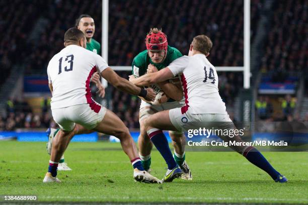 Josh van der Flier is tackled by Max Malins of England during the Six Nations Rugby match between England and Ireland at Twickenham Stadium on March...