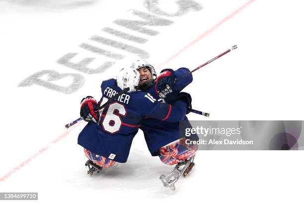 Declan Farmer and Brody Roybal of Team United States celebrate after a goal in the first period against Dominic Larocque of Team Canada during the...