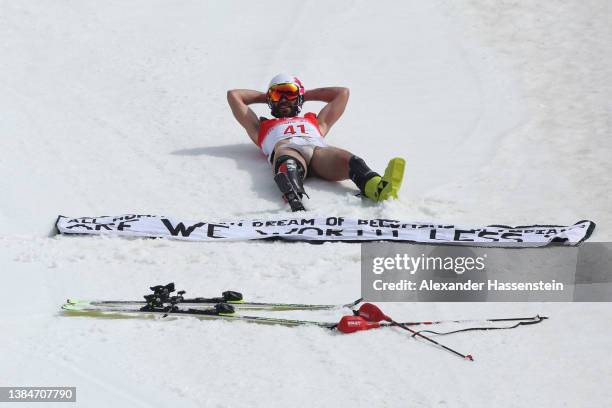 Manoel Bourdenx of Team France displays a message following the Para Alpine Skiing Men's Slalom Standing during day nine of the Beijing 2022 Winter...