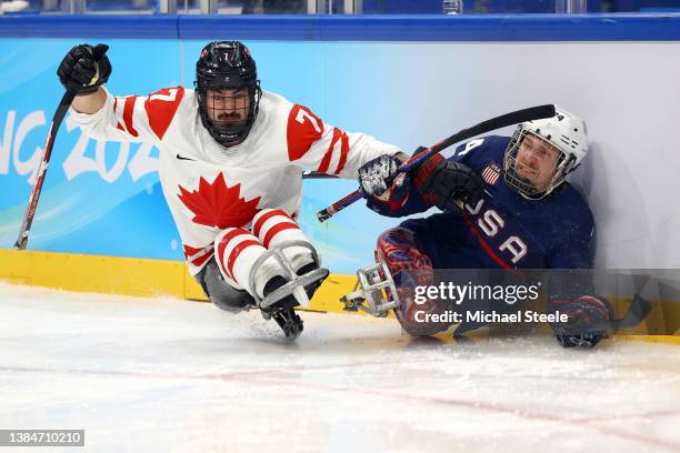 Zach Lavin of Team Canada collides with Joshua Misiewicz of Team United States in the third period during the Para Ice Hockey Gold Medal game on day...