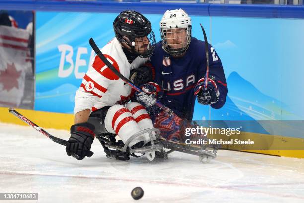 Zach Lavin of Team Canada collides with Joshua Misiewicz of Team United States in the third period during the Para Ice Hockey Gold Medal game on day...
