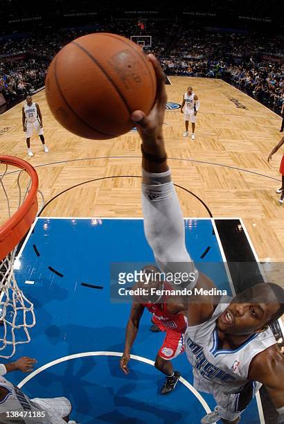 Dwight Howard of the Orlando Magic goes in for a dunk as Reggie Evans of the Los Angeles Clippers looks on during the game on February 6, 2012 at...