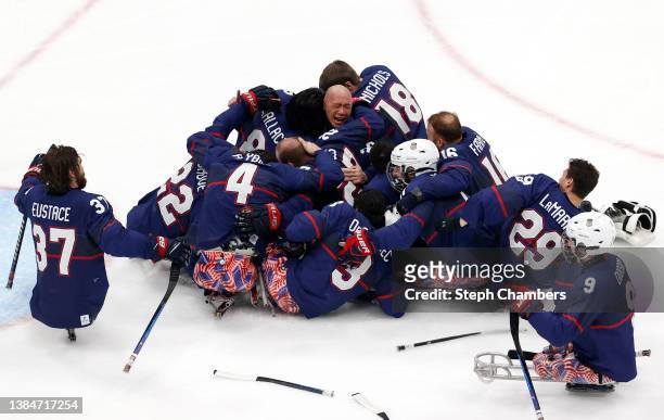 Jen Lee of Team United States celebrates with teammates after defeating Team Canada during the Para Ice Hockey Gold Medal game on day nine of the...