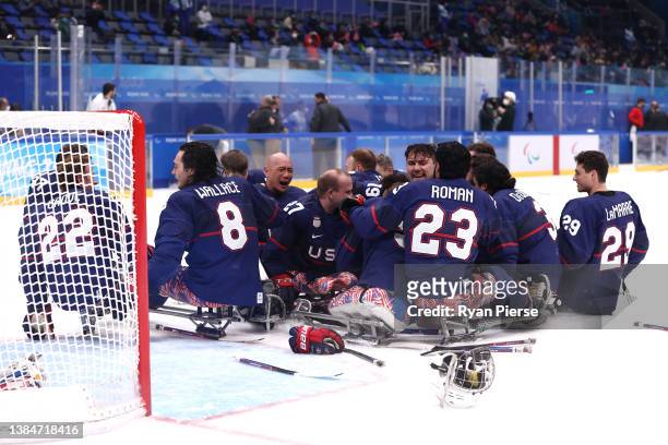 Jen Lee of Team United States celebrates with teammates Jack Wallace, Josh Pauls, Rico Roman and Noah Grove after defeating Team Canada during the...