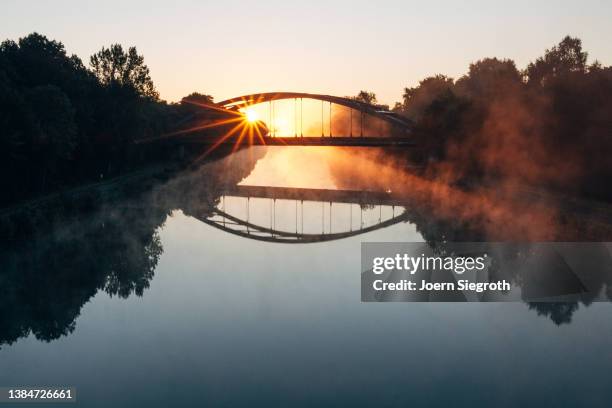 sunrise at a bridge - hängebrücke stock-fotos und bilder