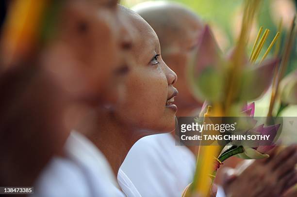 Cambodian nuns pray during the Meak Bochea ceremony at Oddong mountain in Kandal province, some 40 kilometers north of Phnom Penh on February 7,...