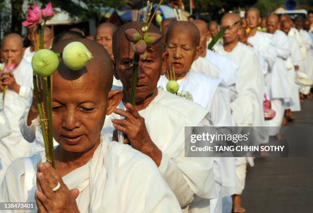 Cambodian nuns march during the Meak Bochea ceremony at Oddong mountain in Kandal province, some 40 kilometers north of Phnom Penh on February 7,...